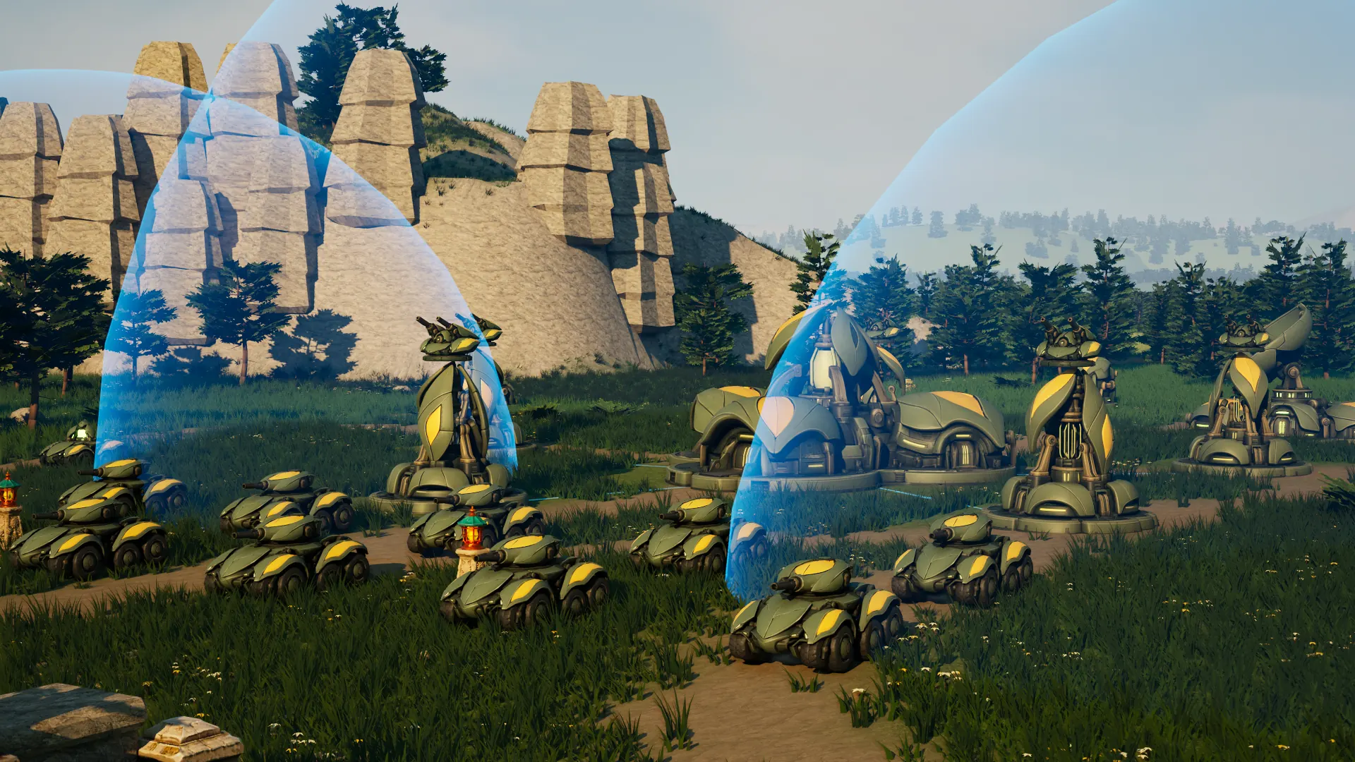 In game: Mossglade's sage-green wheeled tanks wait in the meadow at the start of a match, before their leaf-shaped Heartbloom, its petals and two bubble shields, beneath a limestone outcrop