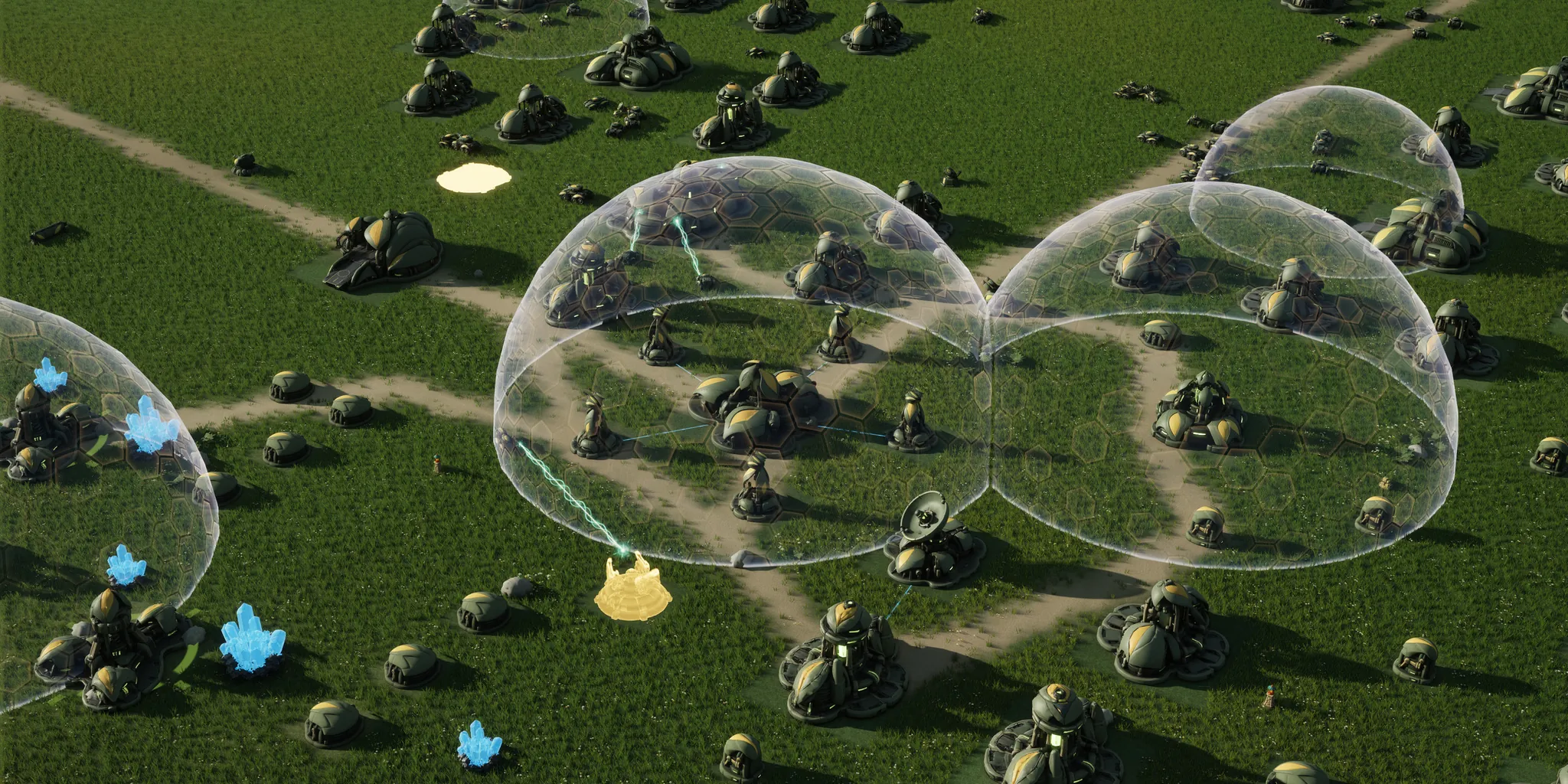 En jeu, vu du ciel : une base Mossglade sur Fourfold Ford, ses bâtiments verts arrondis et ses champs de cristal sous des dômes de bouclier